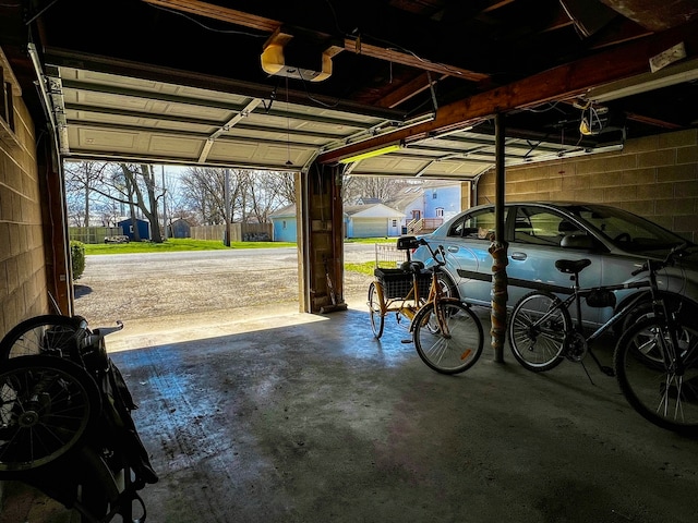 garage with a carport and a garage door opener