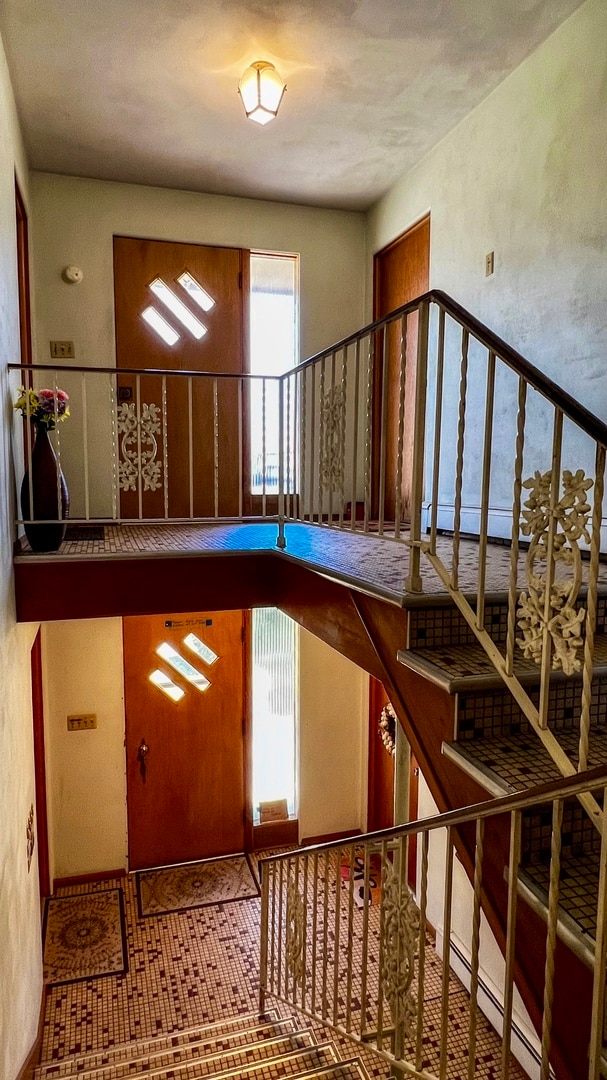 stairs featuring light tile flooring