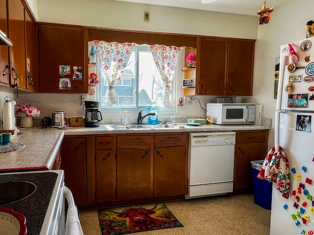 kitchen featuring sink and white appliances