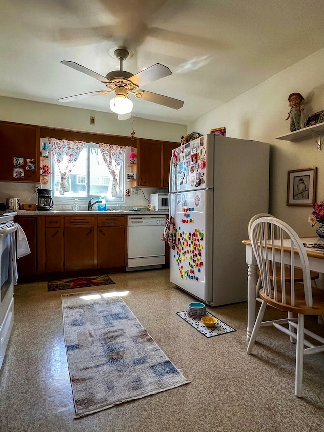 kitchen featuring white appliances and ceiling fan