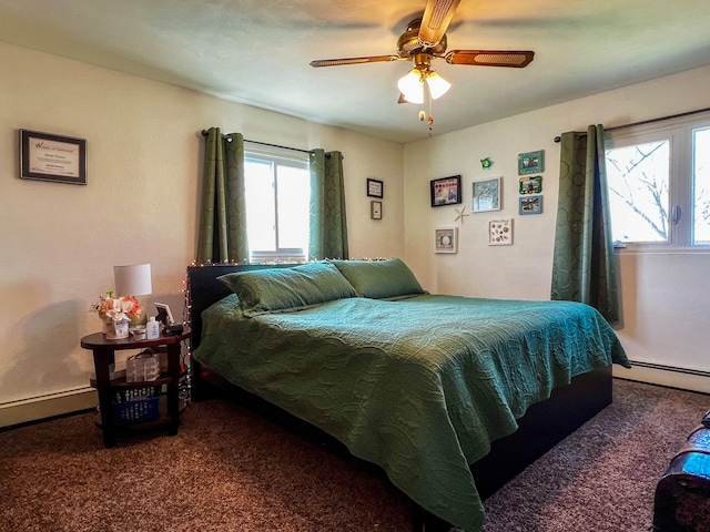 carpeted bedroom with ceiling fan and a baseboard heating unit