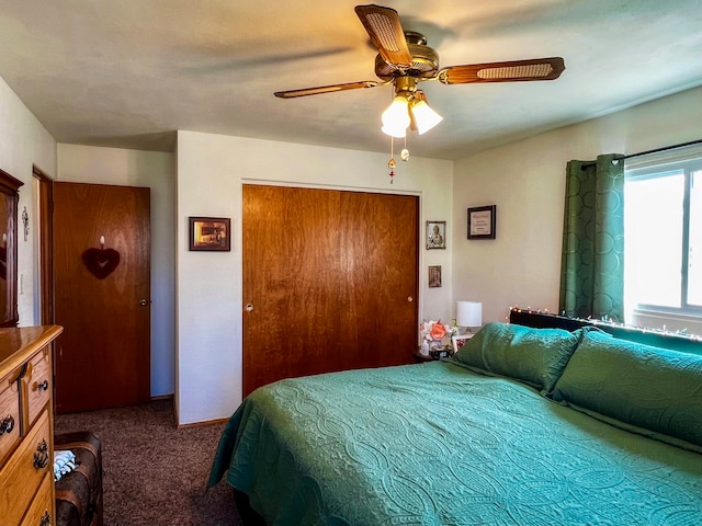 bedroom with a closet, dark carpet, and ceiling fan