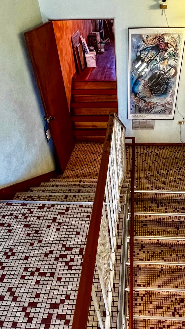 stairs with dark tile floors