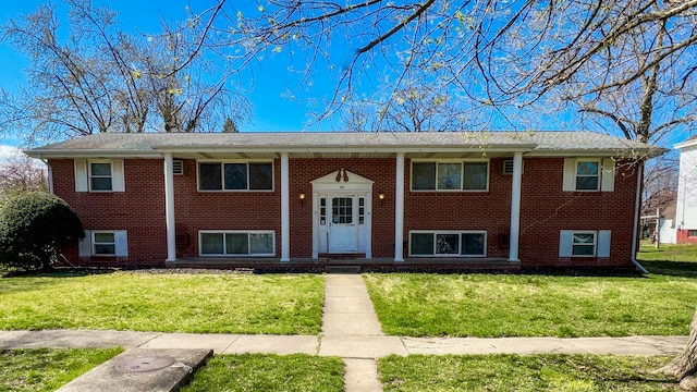 raised ranch featuring a front yard