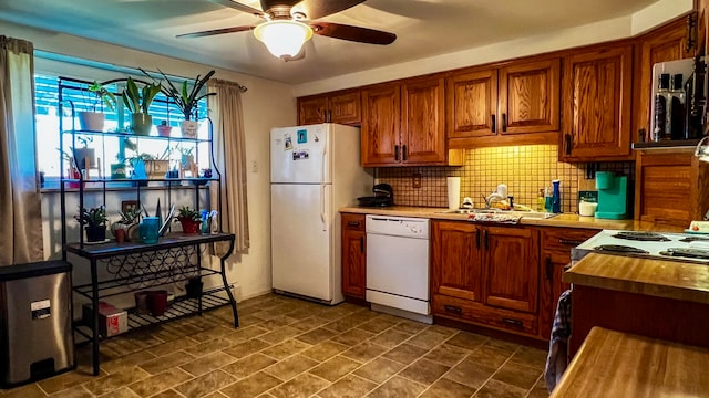 kitchen with white appliances, ceiling fan, dark tile flooring, tasteful backsplash, and sink