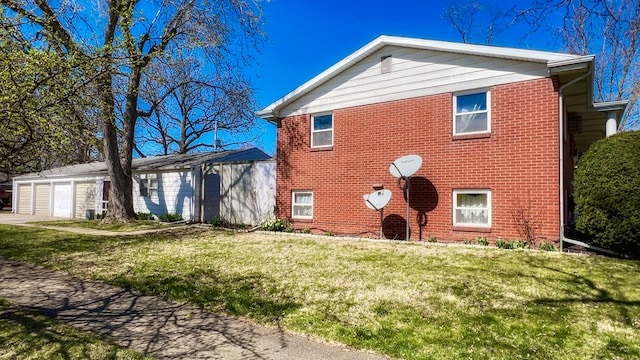 exterior space with a garage and a lawn