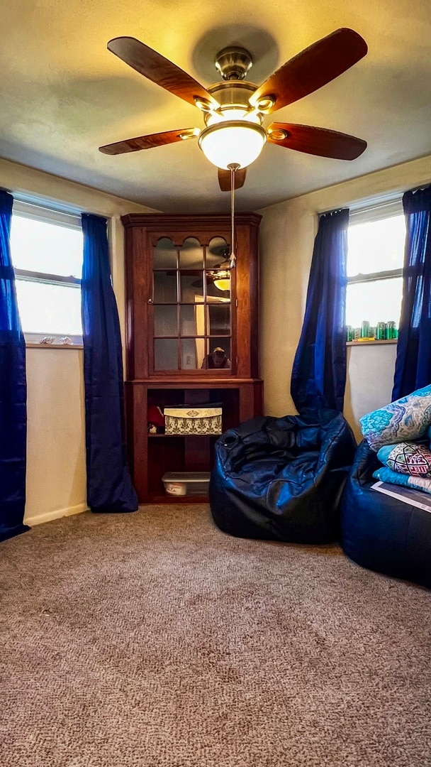 carpeted bedroom with ceiling fan