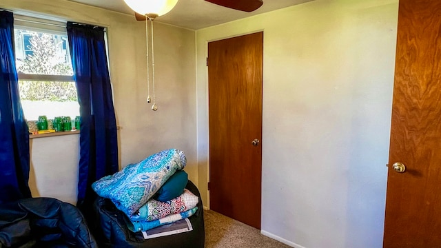 carpeted bedroom featuring multiple windows and ceiling fan