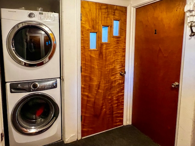 clothes washing area featuring stacked washer and dryer