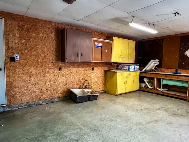 interior space with concrete flooring and a paneled ceiling