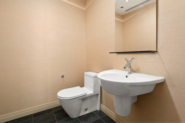 bathroom featuring tile flooring and toilet