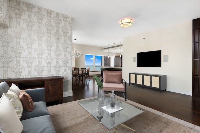 living room featuring a chandelier and dark wood-type flooring