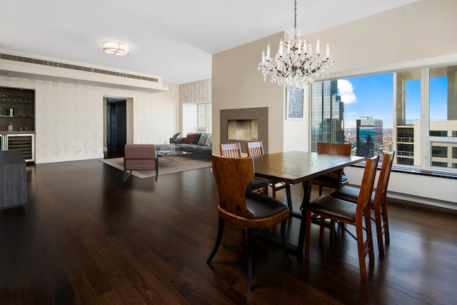 dining space featuring a notable chandelier, dark wood-type flooring, and a wealth of natural light