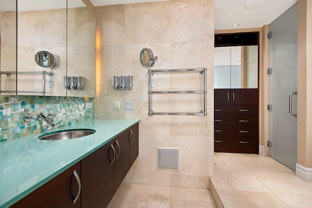 bathroom featuring vanity, tile floors, tasteful backsplash, and tile walls