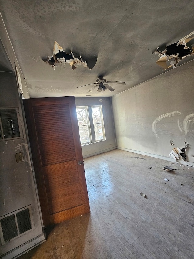 interior space featuring wood-type flooring and ceiling fan