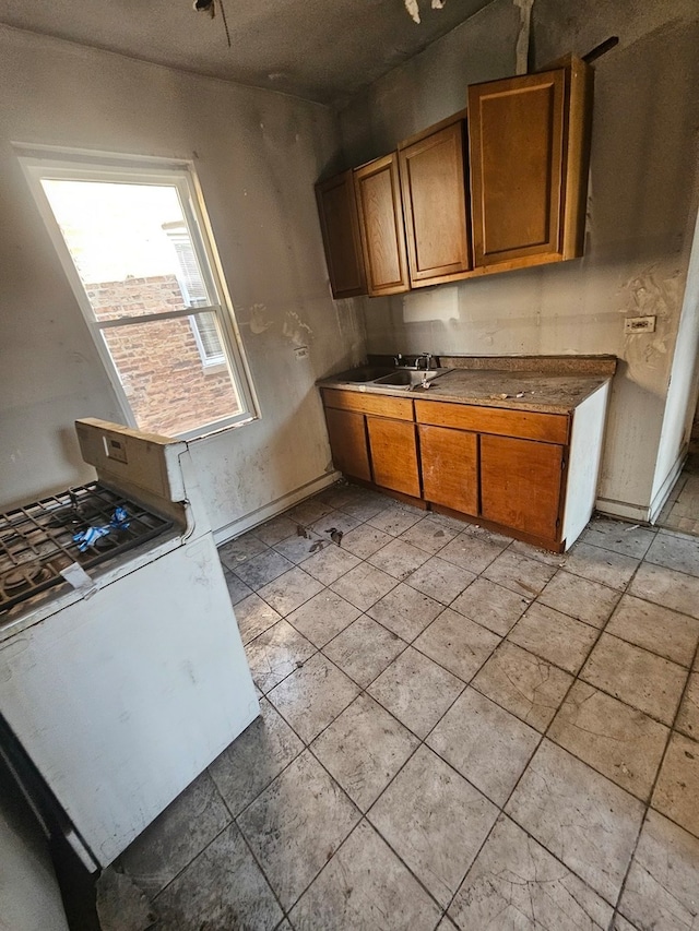 kitchen featuring sink and light tile floors