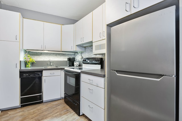 kitchen featuring sink, white cabinets, backsplash, light hardwood / wood-style floors, and black appliances