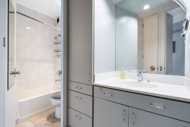 full bathroom with tiled shower / bath combo, tile floors, toilet, and vanity