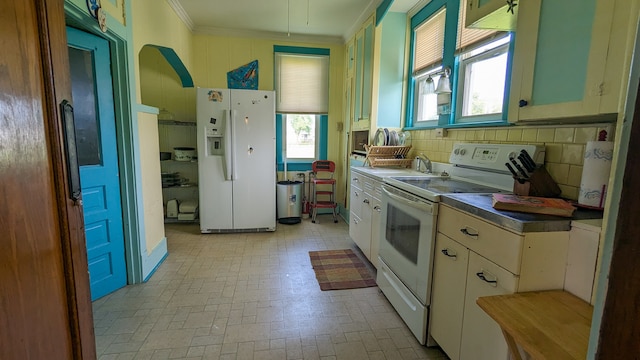 kitchen featuring white appliances, ornamental molding, backsplash, and light tile floors