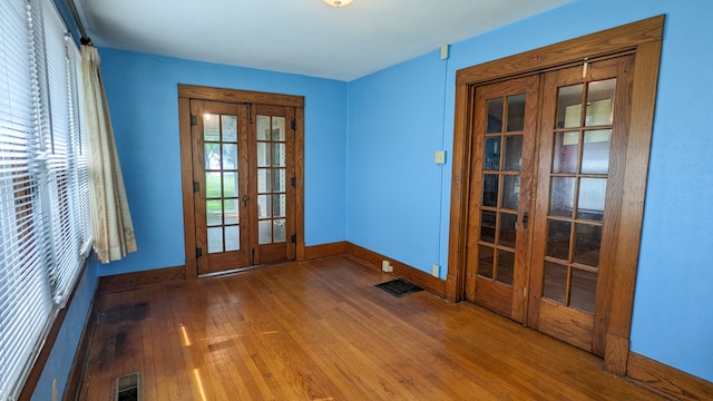 empty room with french doors and dark wood-type flooring