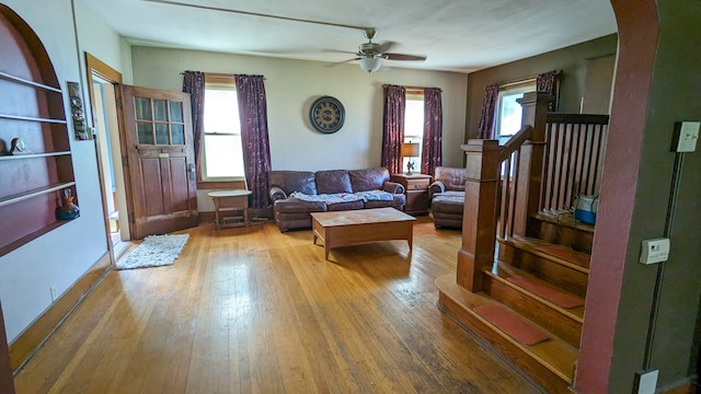 living room with wood-type flooring, plenty of natural light, and ceiling fan