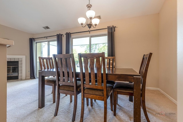 1405 Apricot Ct Unit D, Mount Prospect, IL 60056 - dining room featuring light carpet, baseboards, a chandelier, and a tiled fireplace