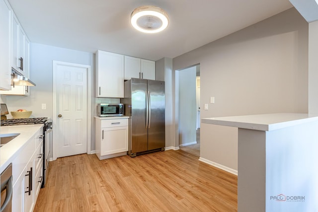 1405 Apricot Ct Unit D, Mount Prospect, IL 60056 - kitchen featuring stainless steel appliances, light wood-style flooring, white cabinets, and under cabinet range hood