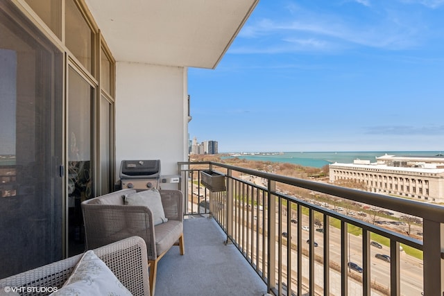 balcony featuring a water view and a view of the beach