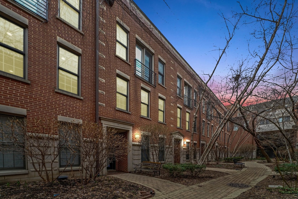 view of outdoor building at dusk