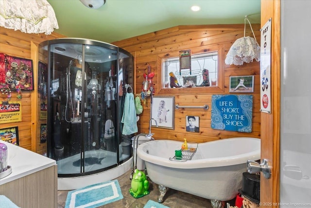 9018 S Brandon Ave, Chicago, IL 60617 - bathroom with wood walls, a stall shower, lofted ceiling, a freestanding tub, and vanity