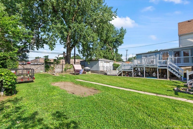 9018 S Brandon Ave, Chicago, IL 60617 - view of yard with stairway, a deck, and a storage shed