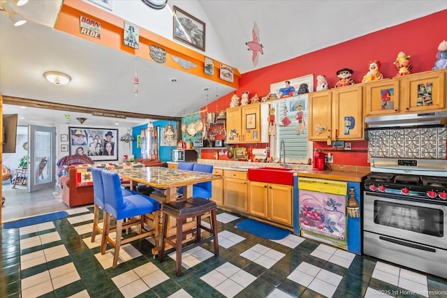 9018 S Brandon Ave, Chicago, IL 60617 - kitchen with stainless steel range oven, under cabinet range hood, lofted ceiling, dark tile patterned floors, and light countertops