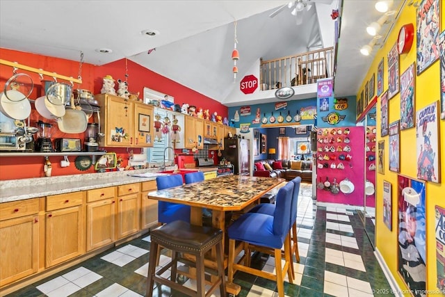 9018 S Brandon Ave, Chicago, IL 60617 - kitchen featuring dark tile patterned flooring, freestanding refrigerator, light countertops, a ceiling fan, and brown cabinetry