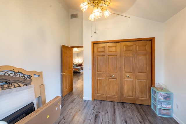 bedroom featuring high vaulted ceiling, a closet, ceiling fan, and light wood-type flooring