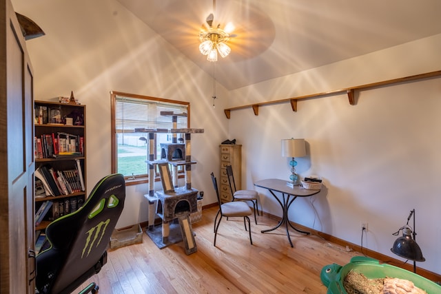 interior space with light wood-type flooring and vaulted ceiling