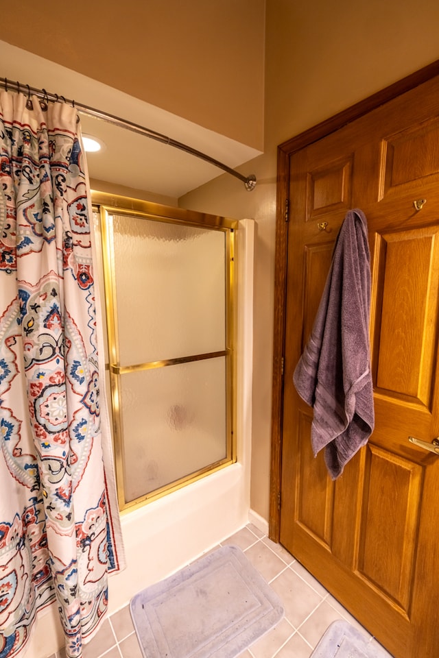 bathroom featuring tile flooring and shower / tub combo