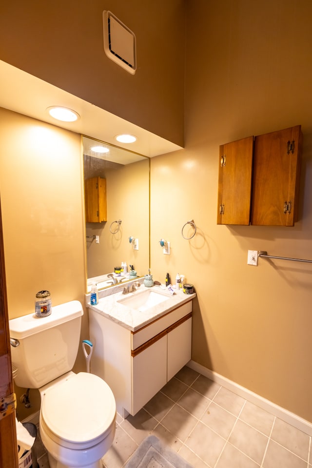 bathroom featuring toilet, tile floors, and vanity