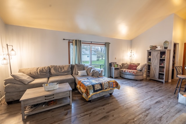 living room featuring high vaulted ceiling and dark hardwood / wood-style floors