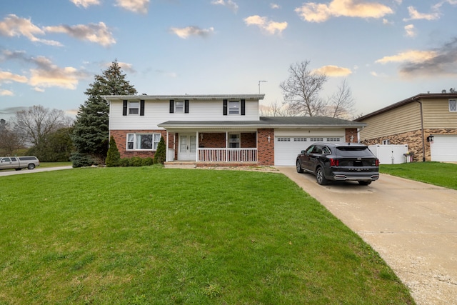 front facade featuring a porch, a front yard, and a garage