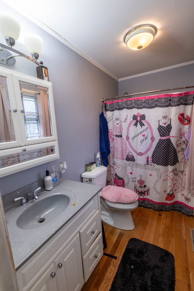 bathroom featuring ornamental molding, toilet, hardwood / wood-style floors, and vanity