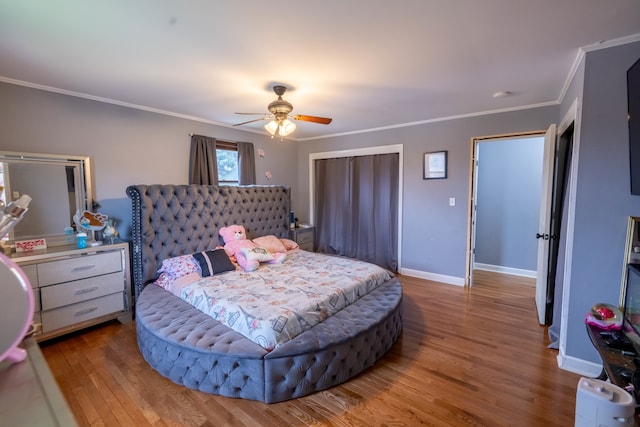 bedroom featuring ceiling fan, ornamental molding, and hardwood / wood-style flooring