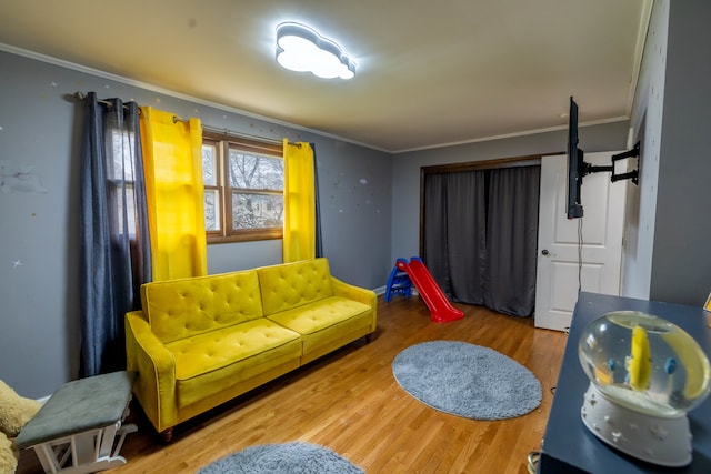 living room featuring crown molding and light wood-type flooring