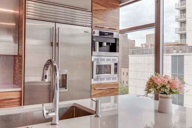 kitchen with a view of city and built in appliances