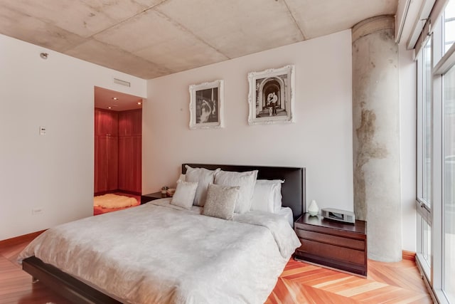 bedroom featuring parquet flooring and visible vents