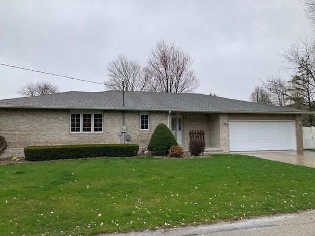 ranch-style home with a front lawn and a garage