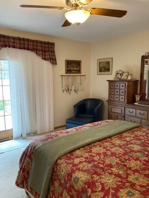 bedroom featuring access to outside, ceiling fan, and light colored carpet