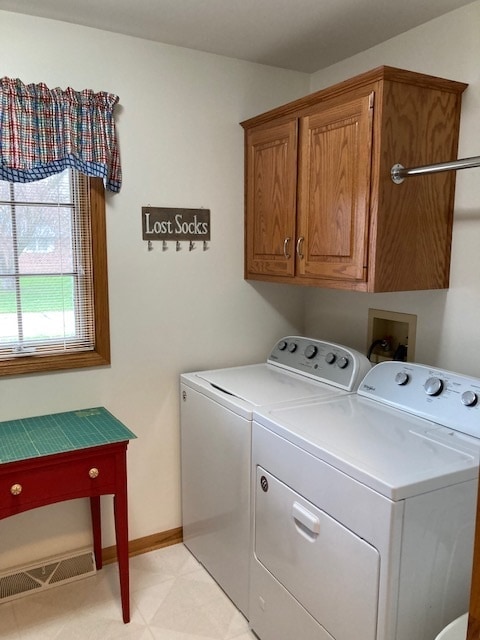 washroom featuring light tile floors, cabinets, separate washer and dryer, and hookup for a washing machine