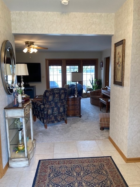 living room with light carpet and ceiling fan