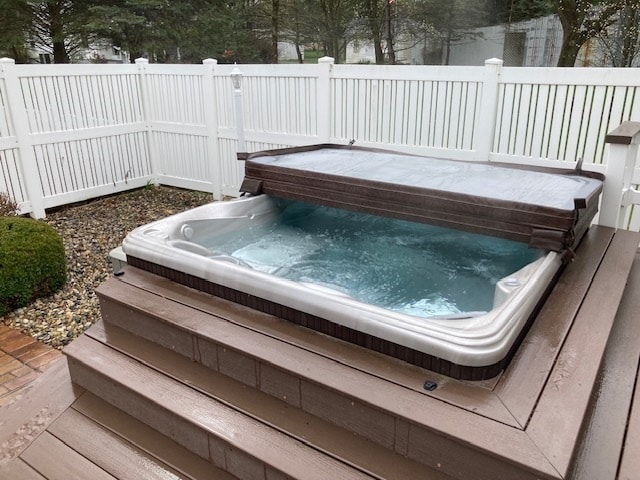 view of pool featuring a covered hot tub