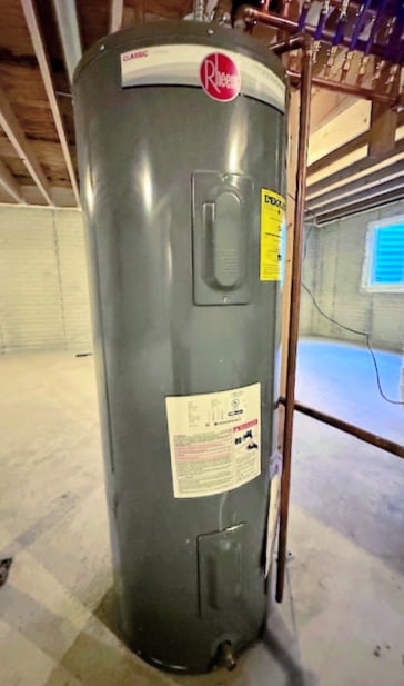 utility room featuring water heater